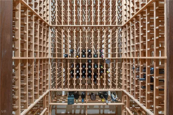 a living room with furniture a large window and gym equipment