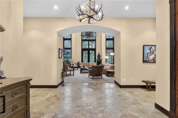 a living room with furniture a large window and a fireplace