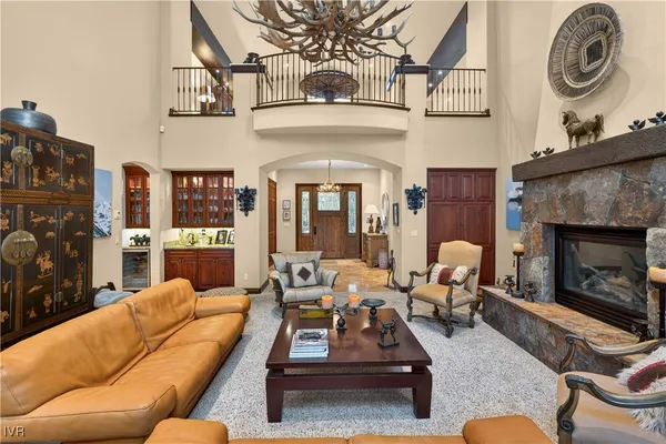 a living room with furniture a rug and a chandelier