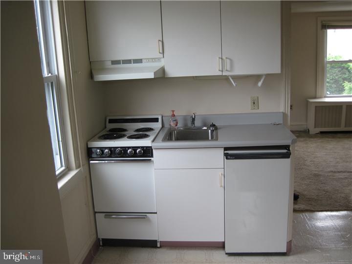 135 Sugartown Road, Unit 2B Wayne, PA 19087 - Photo 6 of 10 a kitchen with cabinets appliances and window