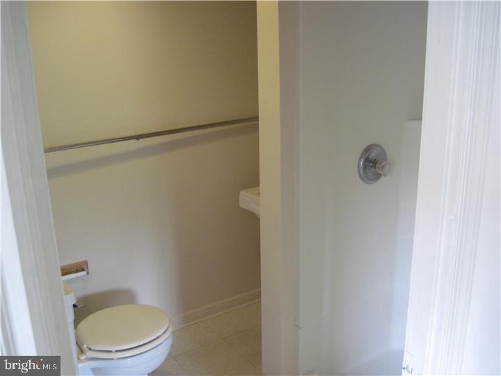135 Sugartown Road, Unit 2B Wayne, PA 19087 - Photo 8 of 10 a white toilet sitting next to a shower