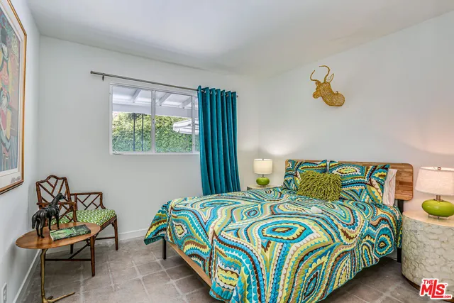 a bedroom with two beds and a window