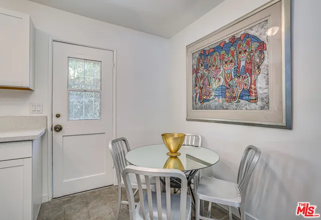 a view of a dining room with furniture and a window