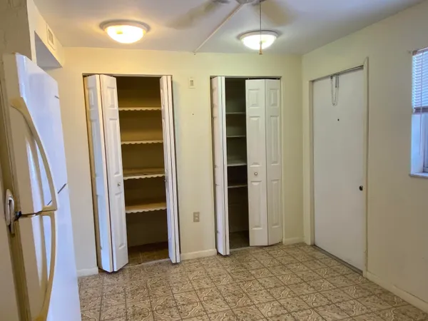 a view of entryway with walk in closet and kitchen