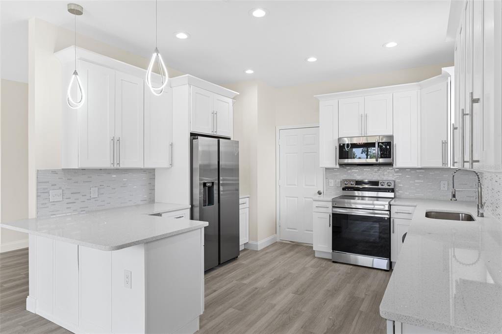 5424 Hammock View Lane Apollo Beach, FL 33572 - Photo 16 of 55 a kitchen with cabinets and stainless steel appliances