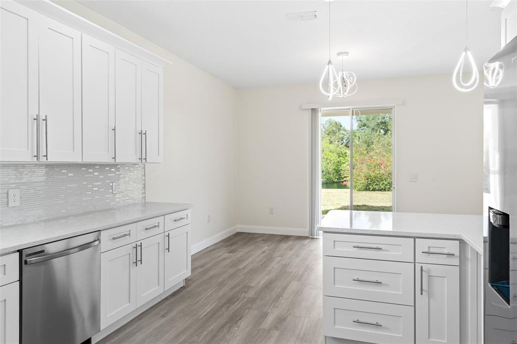 5424 Hammock View Lane Apollo Beach, FL 33572 - Photo 18 of 55 a kitchen with white cabinets and window