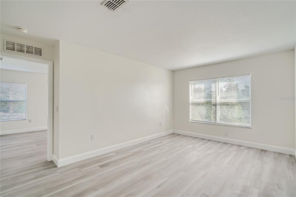 5424 Hammock View Lane Apollo Beach, FL 33572 - Photo 19 of 55 an empty room with wooden floor and windows