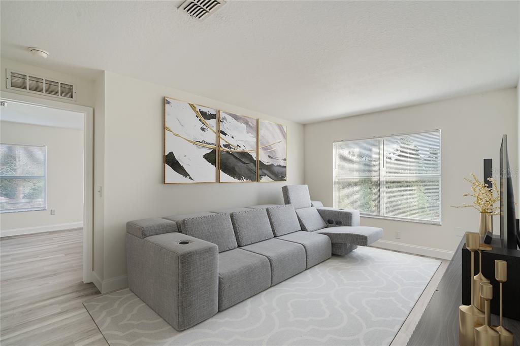 5424 Hammock View Lane Apollo Beach, FL 33572 - Photo 21 of 55 a living room with furniture and a flat screen tv