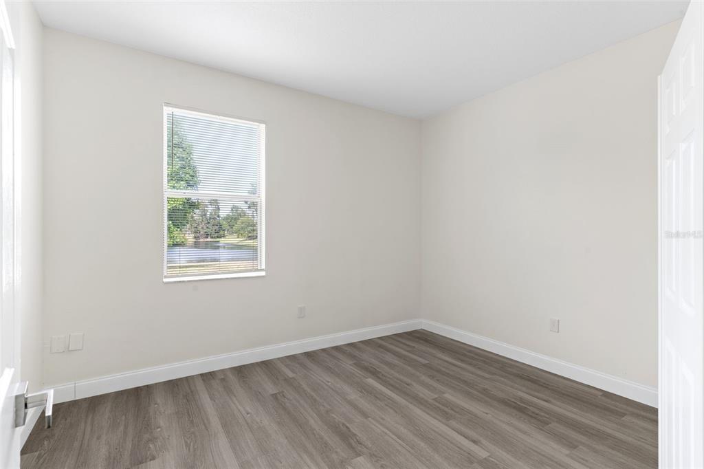 5424 Hammock View Lane Apollo Beach, FL 33572 - Photo 22 of 55 an empty room with wooden floor and windows