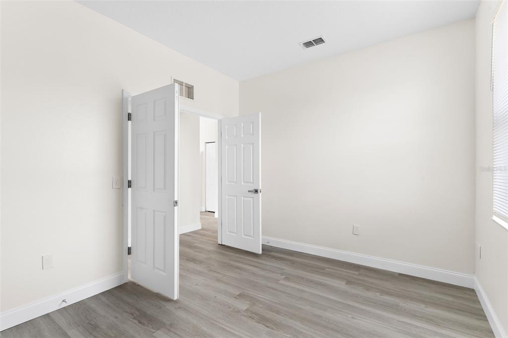 5424 Hammock View Lane Apollo Beach, FL 33572 - Photo 25 of 55 a view of an empty room with wooden floor