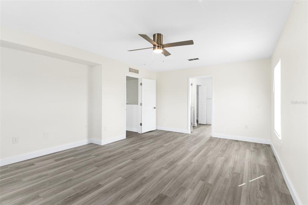 5424 Hammock View Lane Apollo Beach, FL 33572 - Photo 30 of 55 an empty room with wooden floor and windows