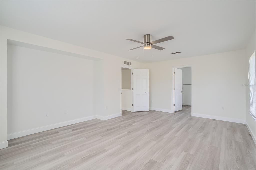 5424 Hammock View Lane Apollo Beach, FL 33572 - Photo 35 of 55 a view of empty room with wooden floor and ceiling fan