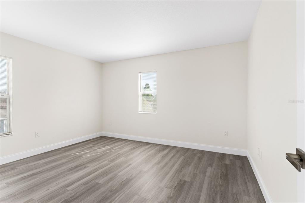 5424 Hammock View Lane Apollo Beach, FL 33572 - Photo 40 of 55 an empty room with wooden floor and windows