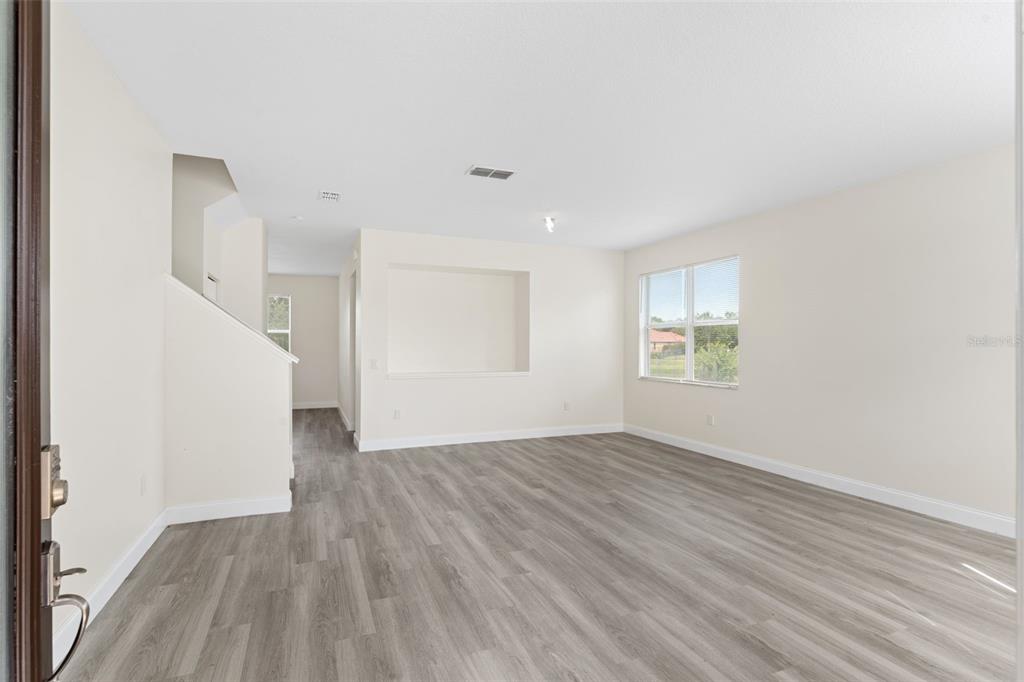5424 Hammock View Lane Apollo Beach, FL 33572 - Photo 5 of 55 an empty room with wooden floor and windows