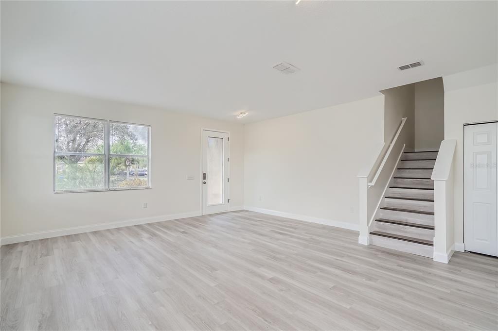 5424 Hammock View Lane Apollo Beach, FL 33572 - Photo 6 of 55 wooden floor in an empty room with a window