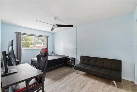 a bedroom with furniture and a window