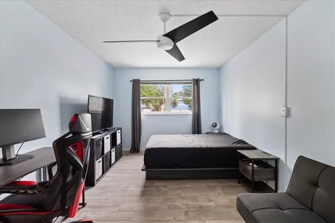 a bedroom with a bed and a desk