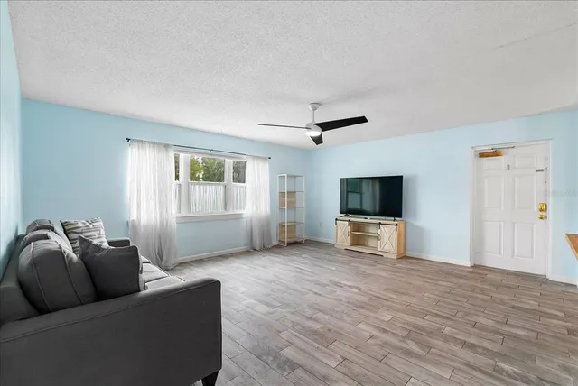 a living room with furniture and kitchen view