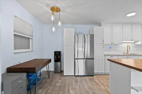 a kitchen with stainless steel appliances granite countertop a refrigerator a sink and a stove