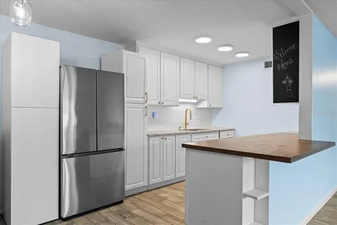 a kitchen with granite countertop a sink a stove and cabinets