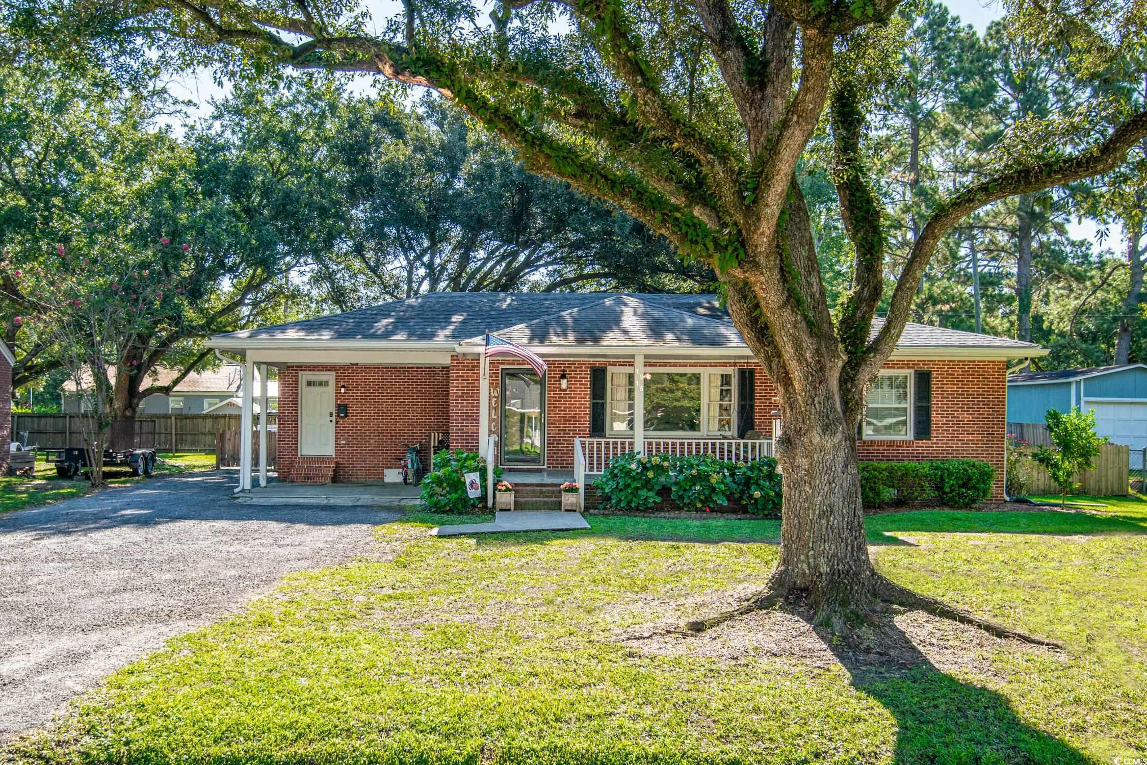 1916 Jasper Street Georgetown, SC 29440 - Photo 1 of 35 Ranch-style house with a porch and a front lawn