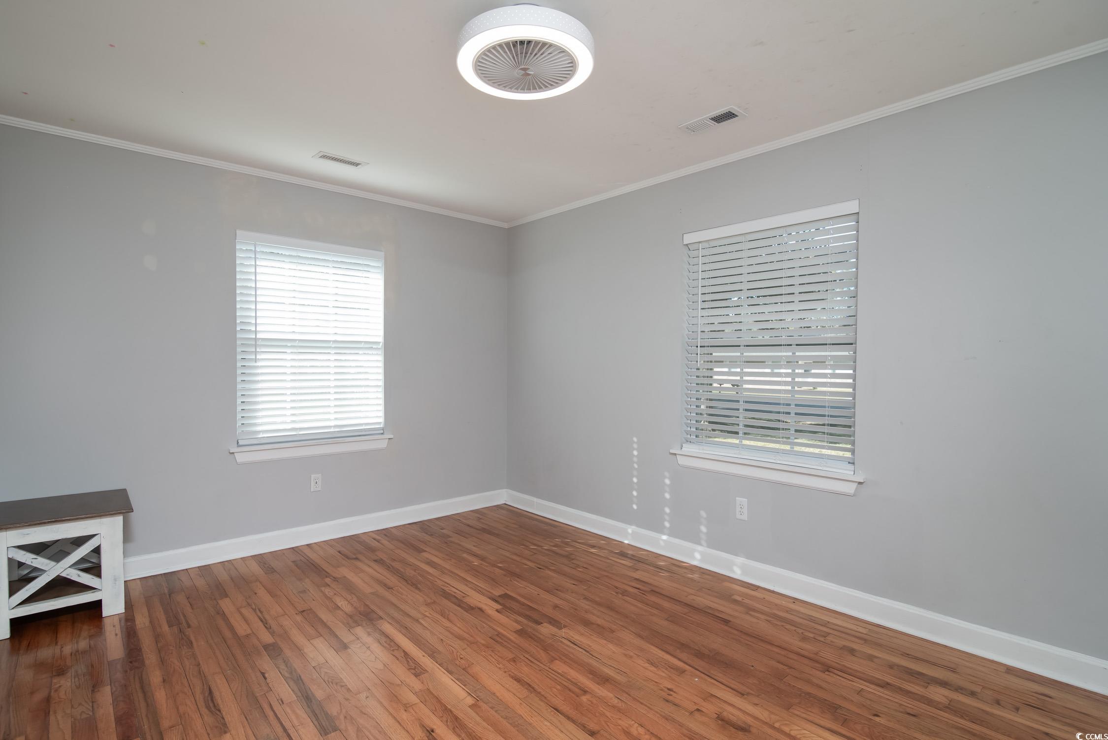 1916 Jasper Street Georgetown, SC 29440 - Photo 16 of 35 Empty room featuring ornamental molding and dark w