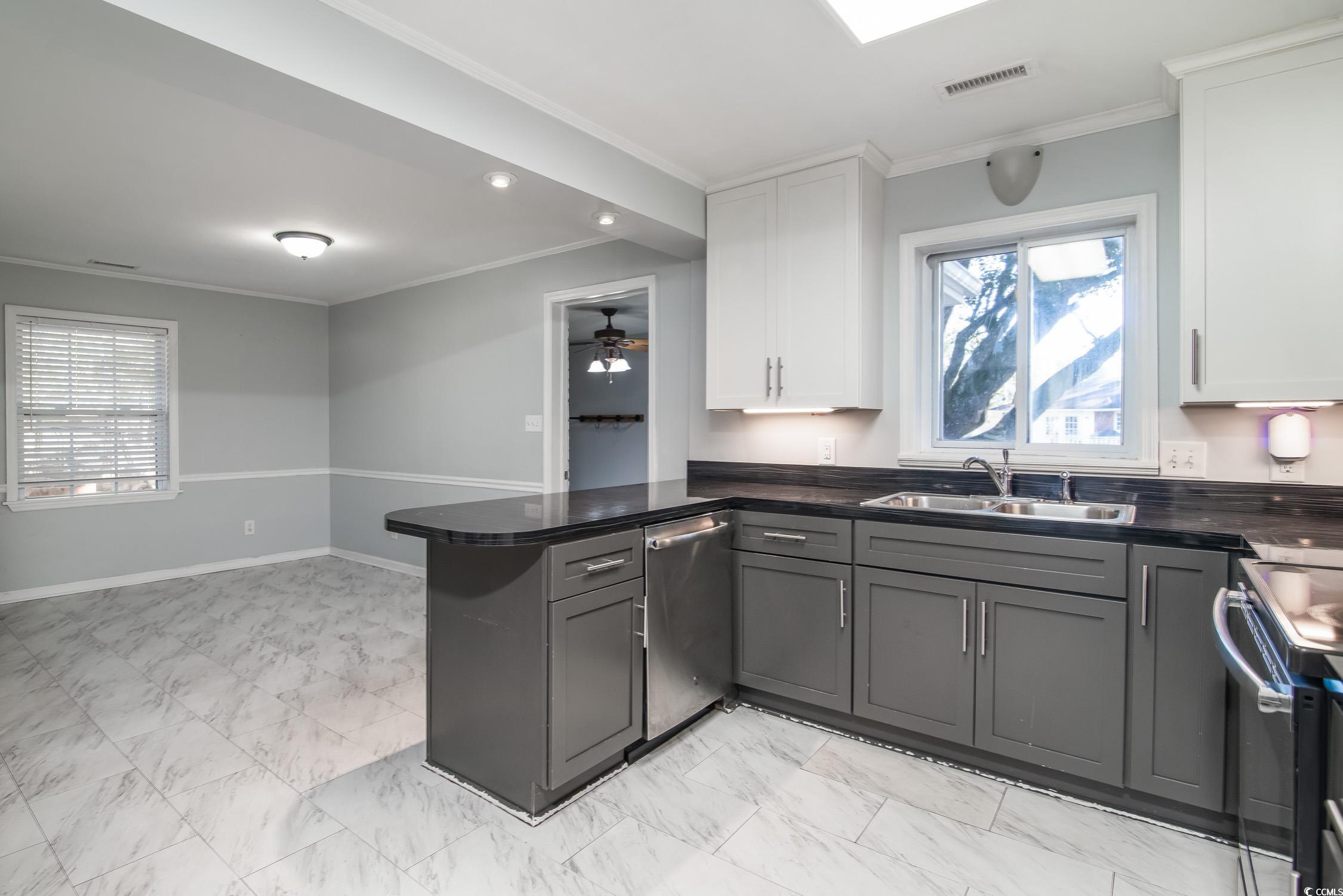 1916 Jasper Street Georgetown, SC 29440 - Photo 20 of 35 Kitchen with kitchen peninsula, white cabinetry, s