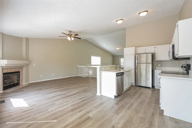 a kitchen with a refrigerator a stove top oven a sink and dishwasher