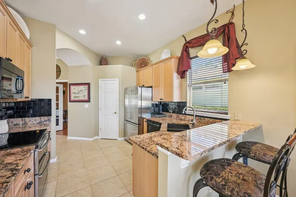 a living room with a bed furniture and a large window