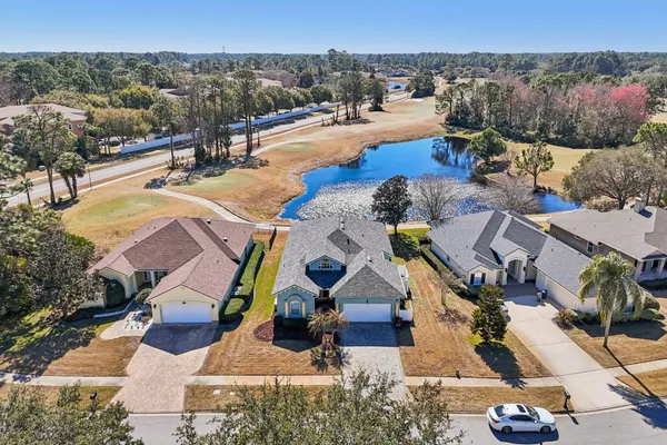 a view of a hallway to a livingroom with furniture and window