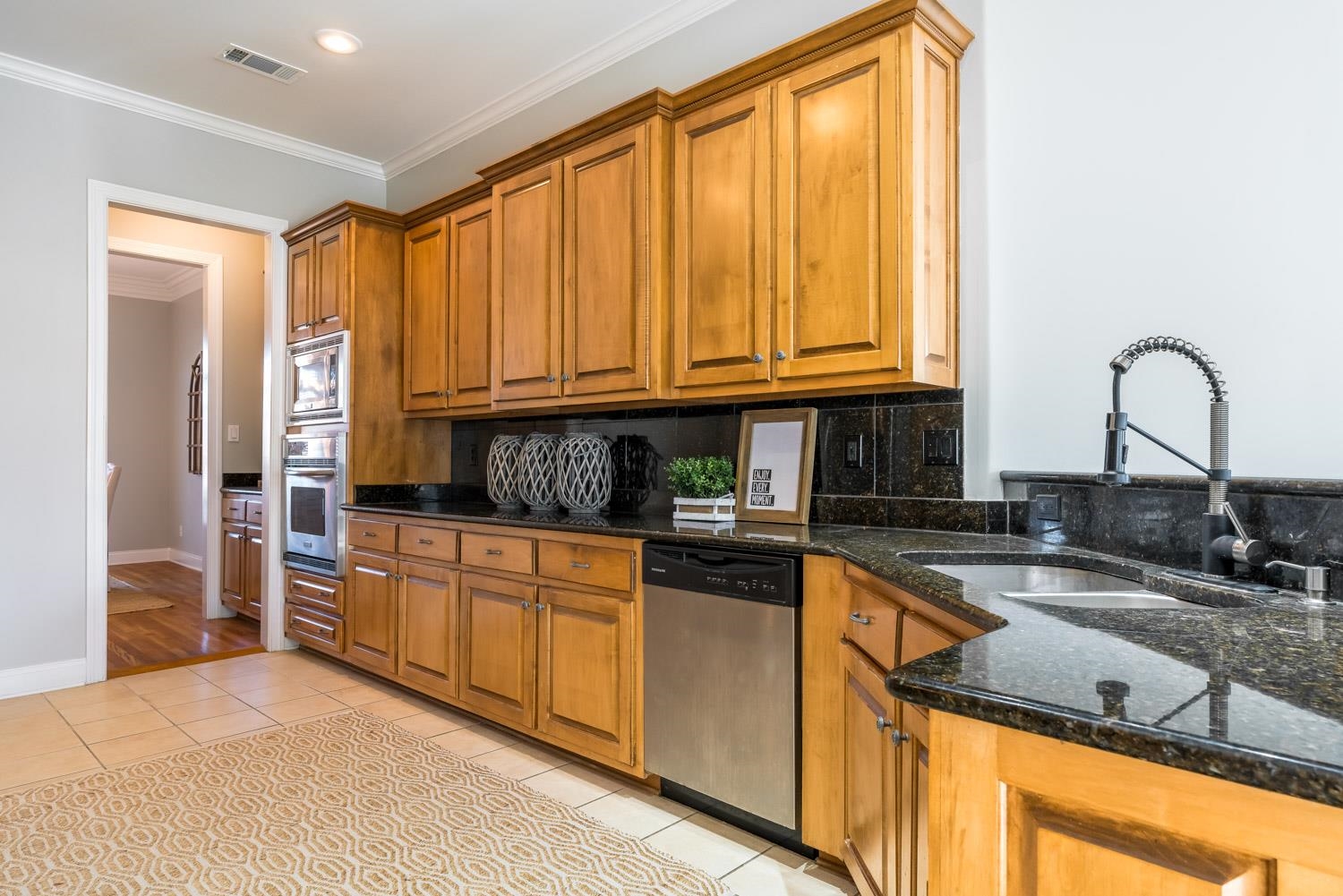 643 Hawks Peaks Road Collierville, TN 38017 - Photo 8 of 25 a kitchen with granite countertop a sink and cabinets