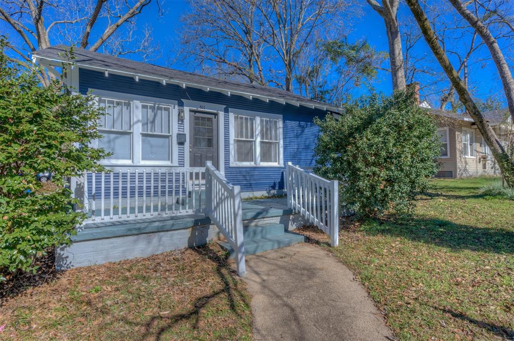 front view of a house with a bench in patio