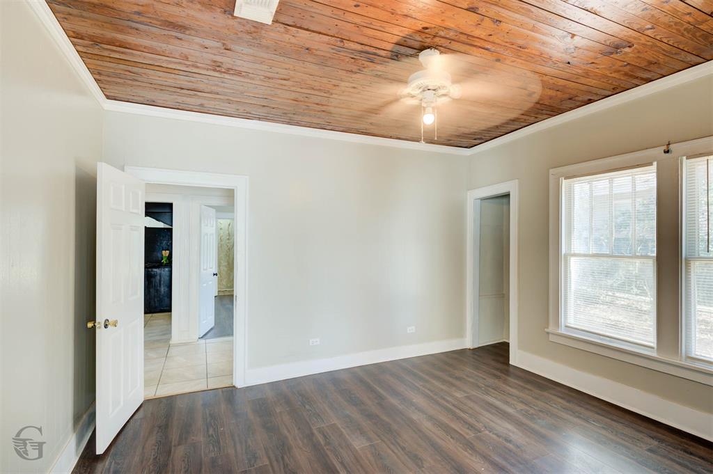 511 Chandler Street Minden, LA 71055 - Photo 12 of 16 en empty room with wooden floor and windows