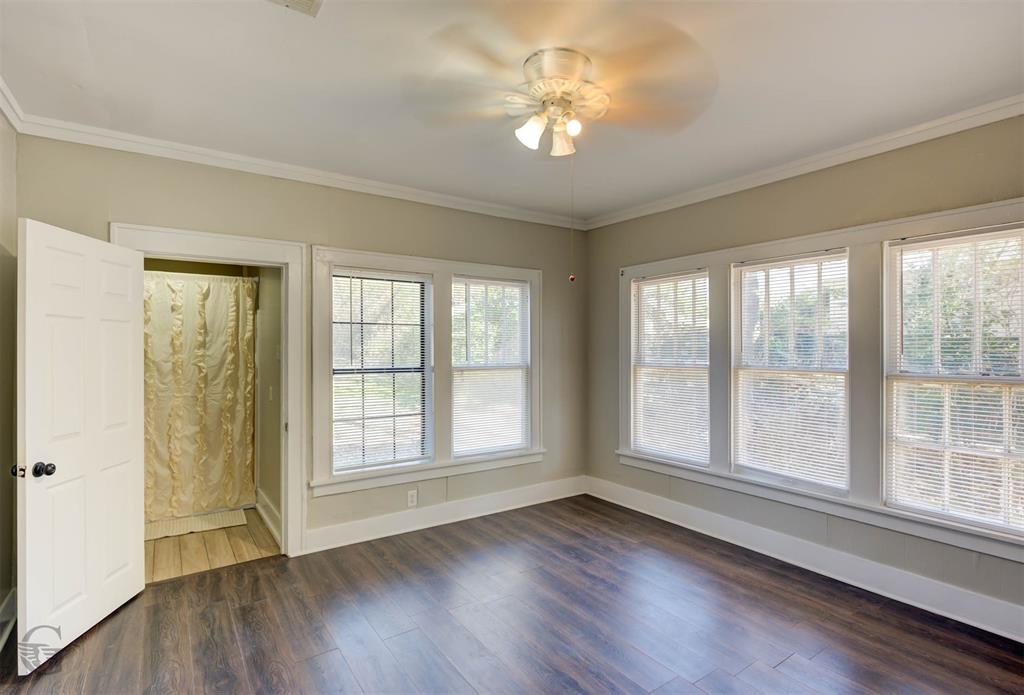 511 Chandler Street Minden, LA 71055 - Photo 14 of 16 a view of an empty room with wooden floor and a window