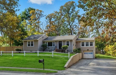 a front view of house with yard and green space
