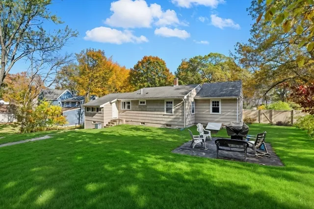 a backyard of a house with table and chairs