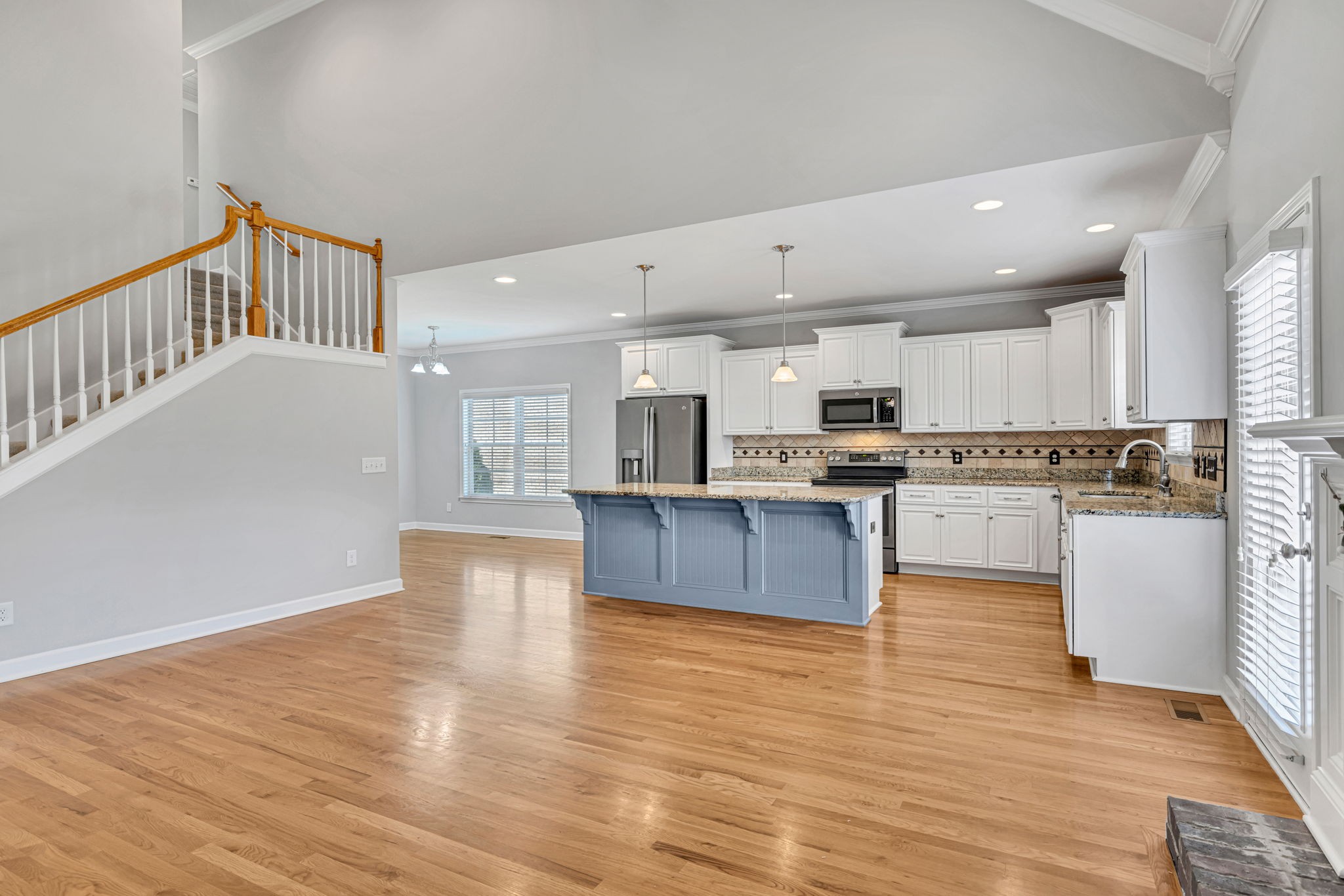 8023 Ragusa Circle Spring Hill, TN 37174 - Photo 13 of 46 a large kitchen with cabinets wooden floor and stainless steel appliances
