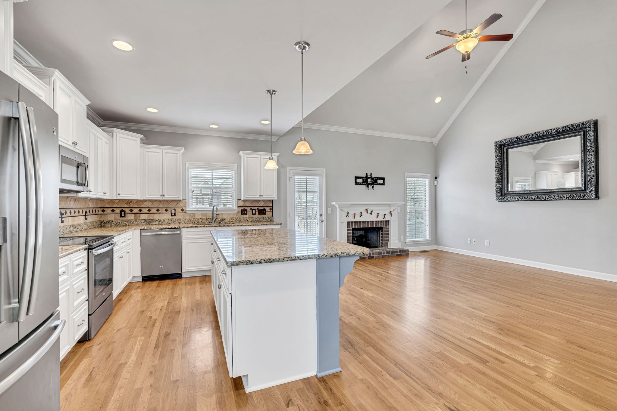 8023 Ragusa Circle Spring Hill, TN 37174 - Photo 17 of 46 a kitchen with white cabinets and stainless steel appliances
