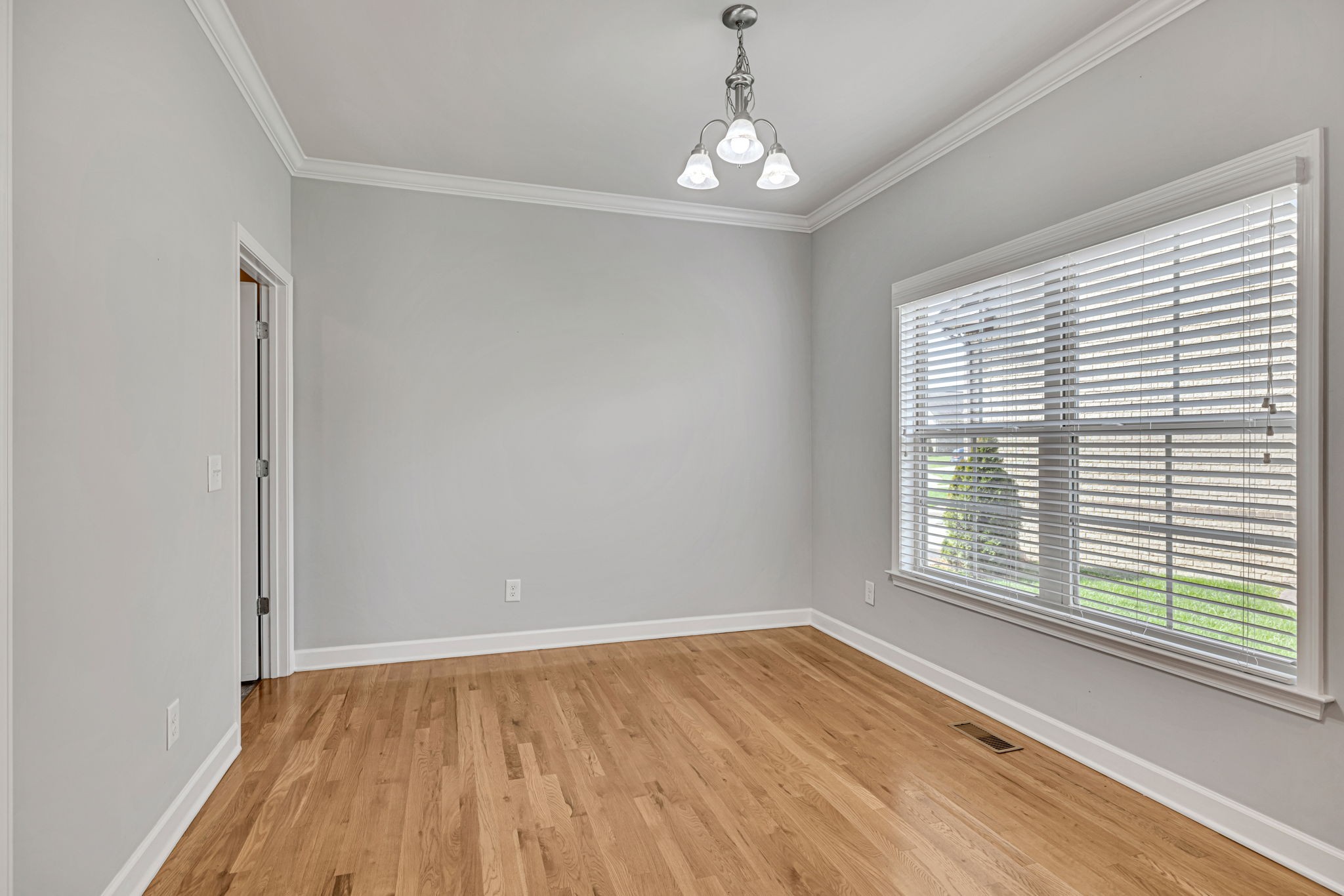 8023 Ragusa Circle Spring Hill, TN 37174 - Photo 22 of 46 a view of an empty room with wooden floor and a window