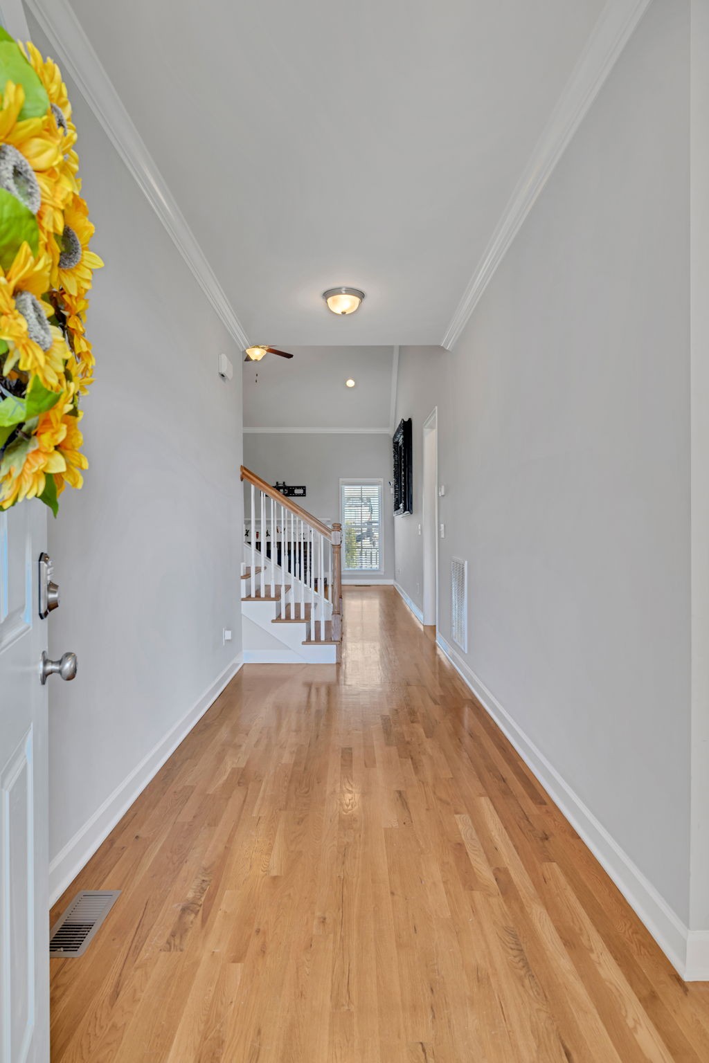 8023 Ragusa Circle Spring Hill, TN 37174 - Photo 3 of 46 a view of a hallway with wooden floor and a potted plant