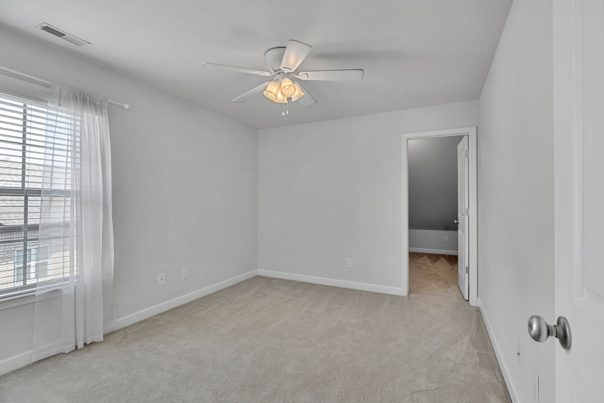 8023 Ragusa Circle Spring Hill, TN 37174 - Photo 38 of 46 an empty room with a chandelier fan and windows