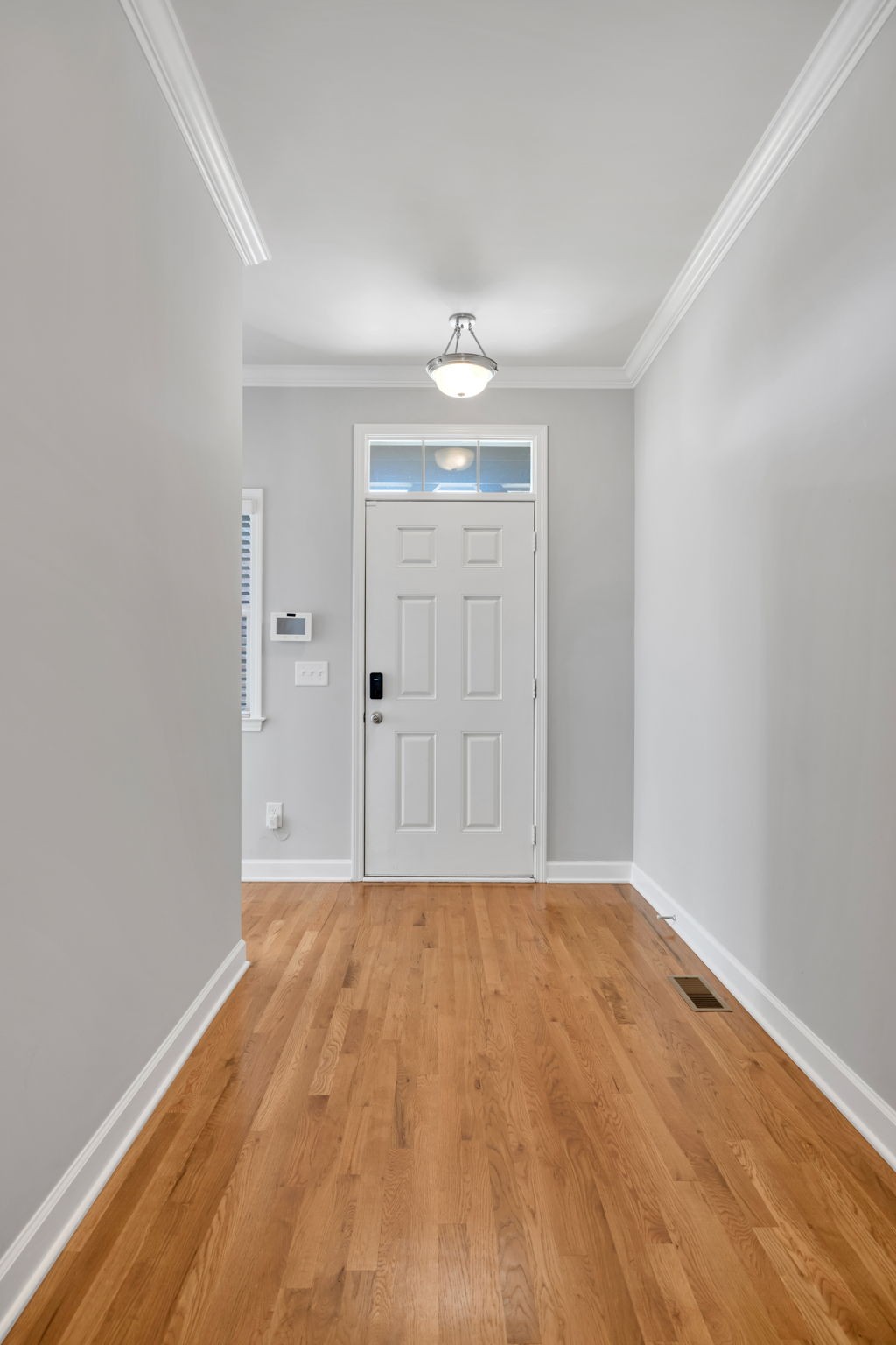 8023 Ragusa Circle Spring Hill, TN 37174 - Photo 4 of 46 a view of an empty room with wooden floor and a window