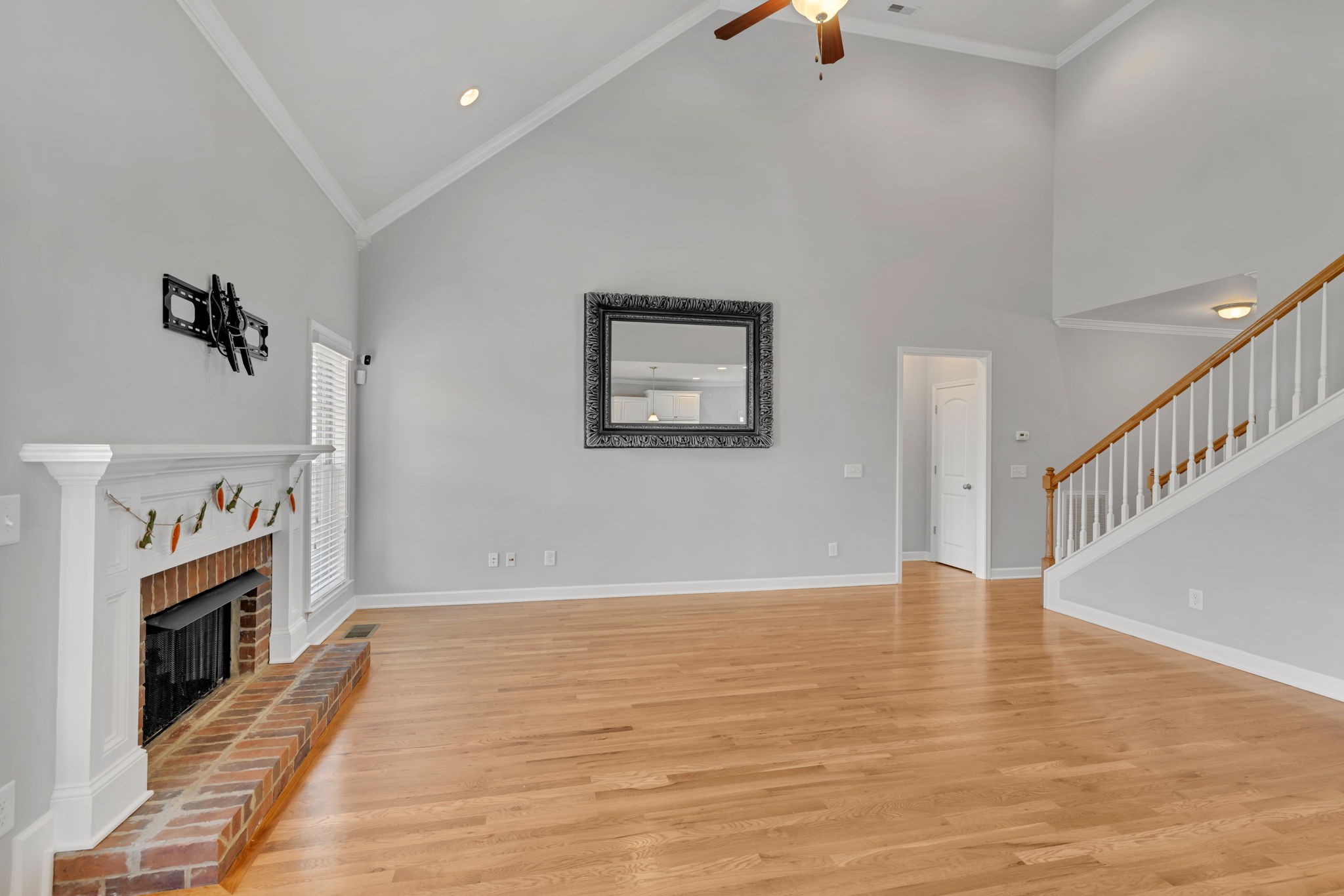 8023 Ragusa Circle Spring Hill, TN 37174 - Photo 10 of 46 a view of an empty room with wooden floor and a fireplace