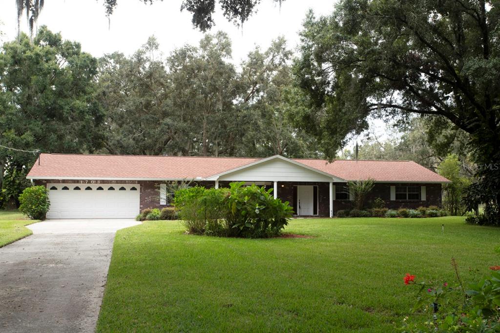 1703 East Sparkman Road Plant City, FL 33566 - Photo 1 of 1 a front view of a house with garden
