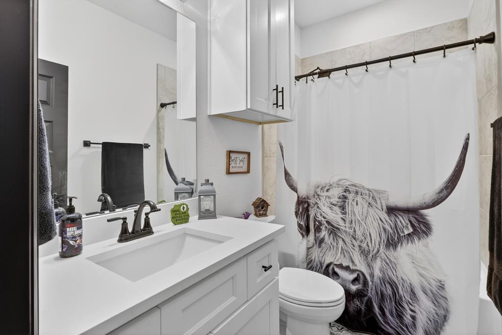 1740 Reverie Road Burleson, TX 76028 - Photo 8 of 37 a bathroom with a sink toilet and shower