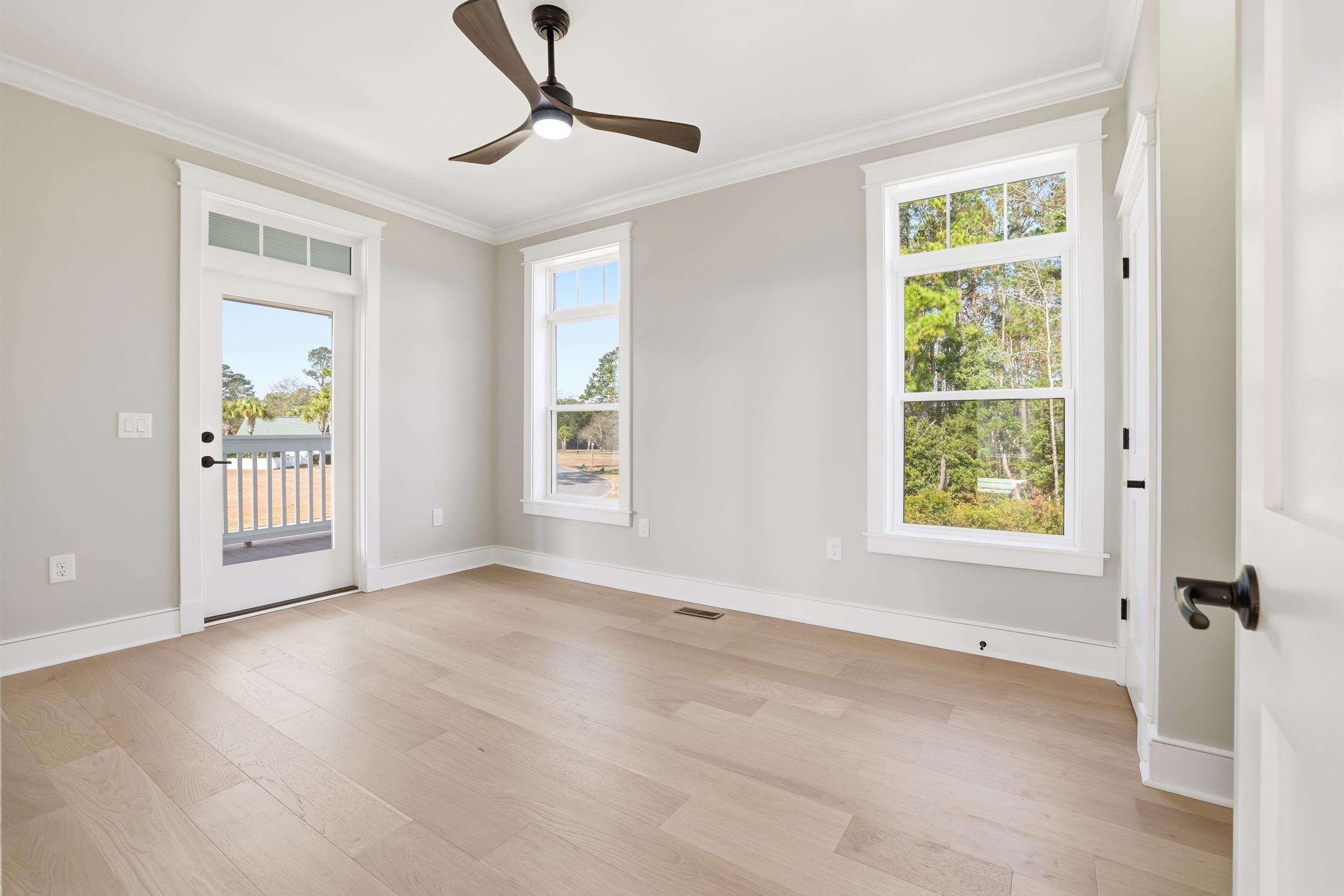 145 Oak Bay Drive Georgetown, SC 29440 - Photo 18 of 39 Spare room featuring crown molding, light wood-style flooring, plenty of natural light, and ceiling fan