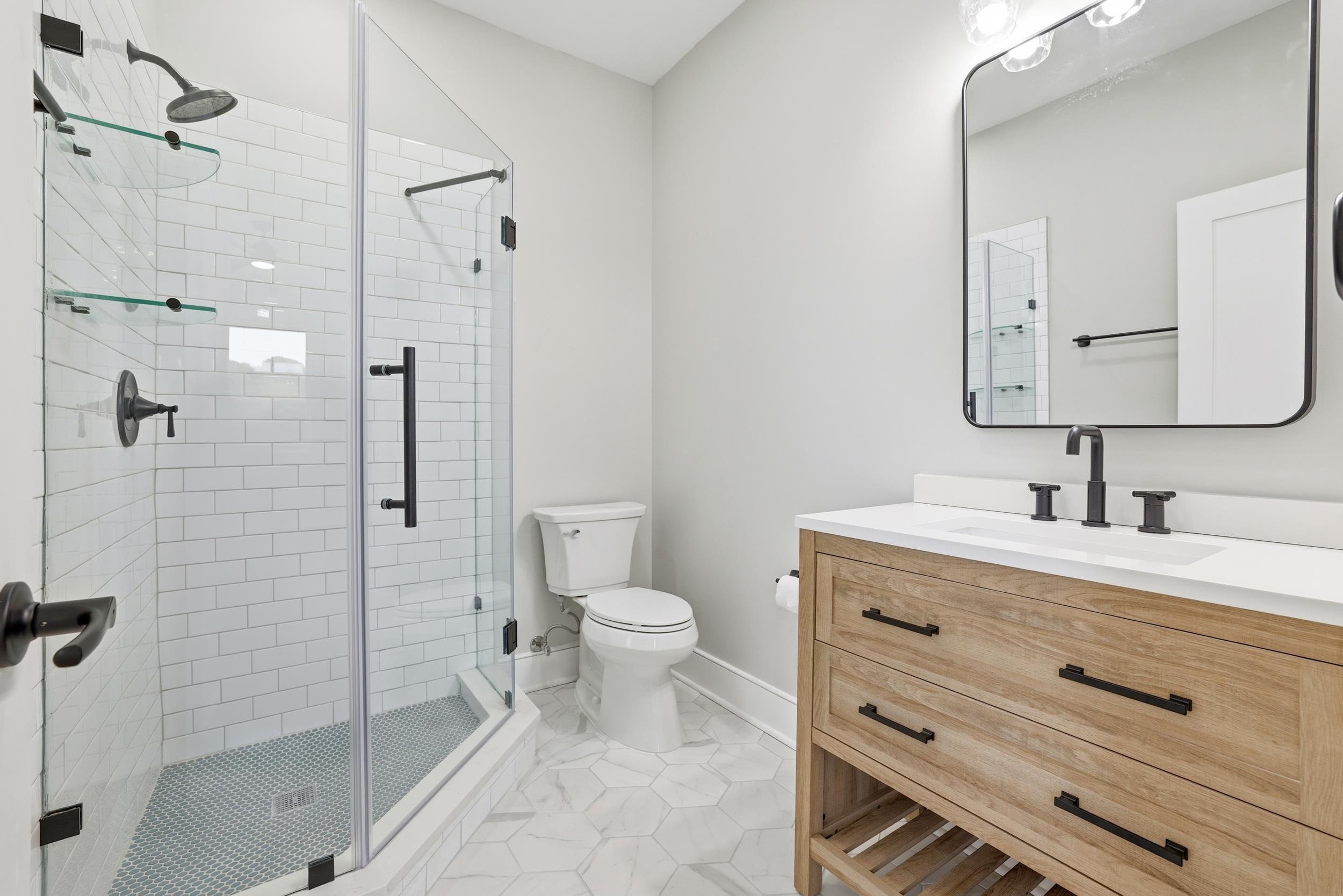 145 Oak Bay Drive Georgetown, SC 29440 - Photo 23 of 39 Bathroom featuring vanity, light tile patterned flooring, and a shower stall