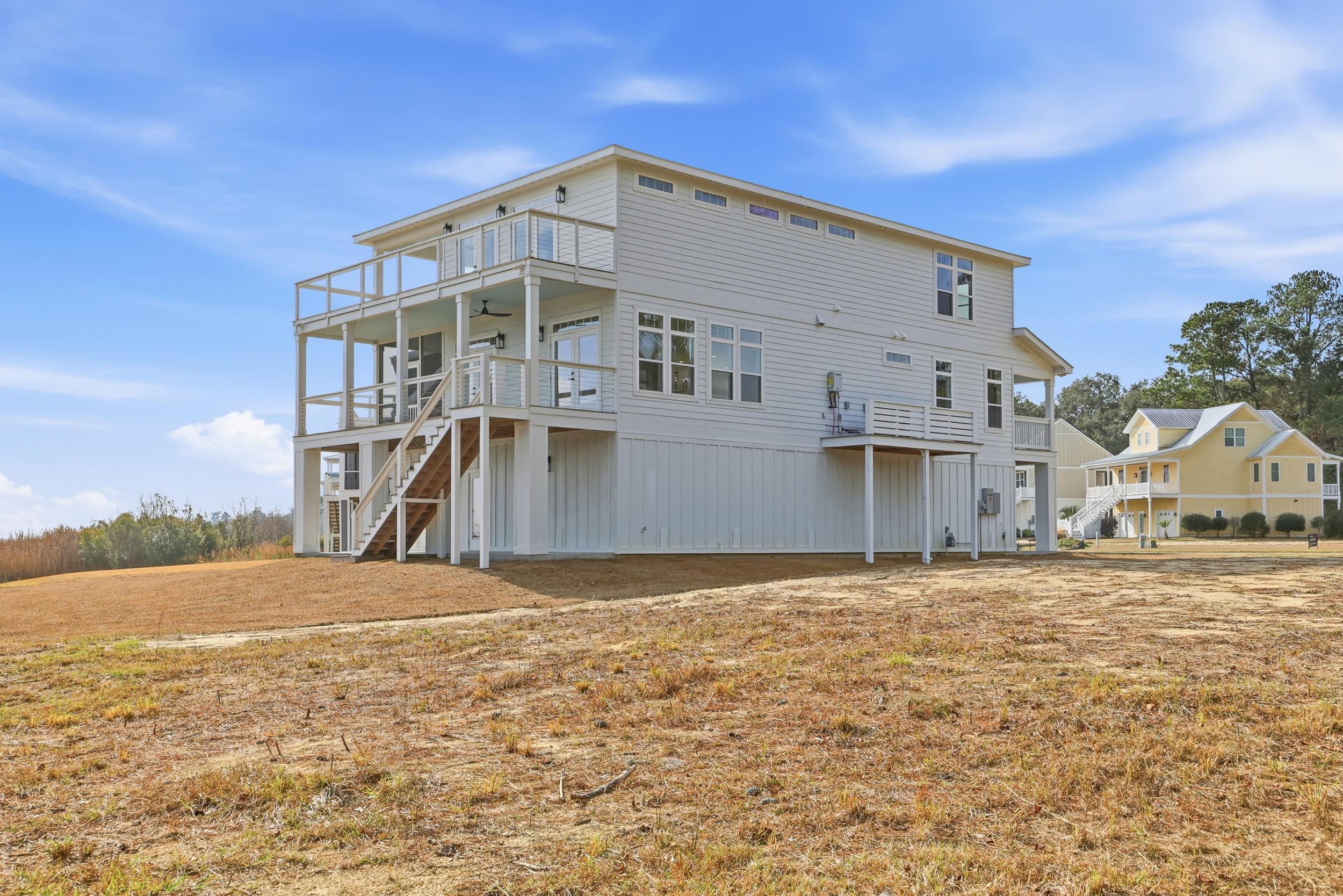 145 Oak Bay Drive Georgetown, SC 29440 - Photo 33 of 39 Back of property featuring stairway and a ceiling fan