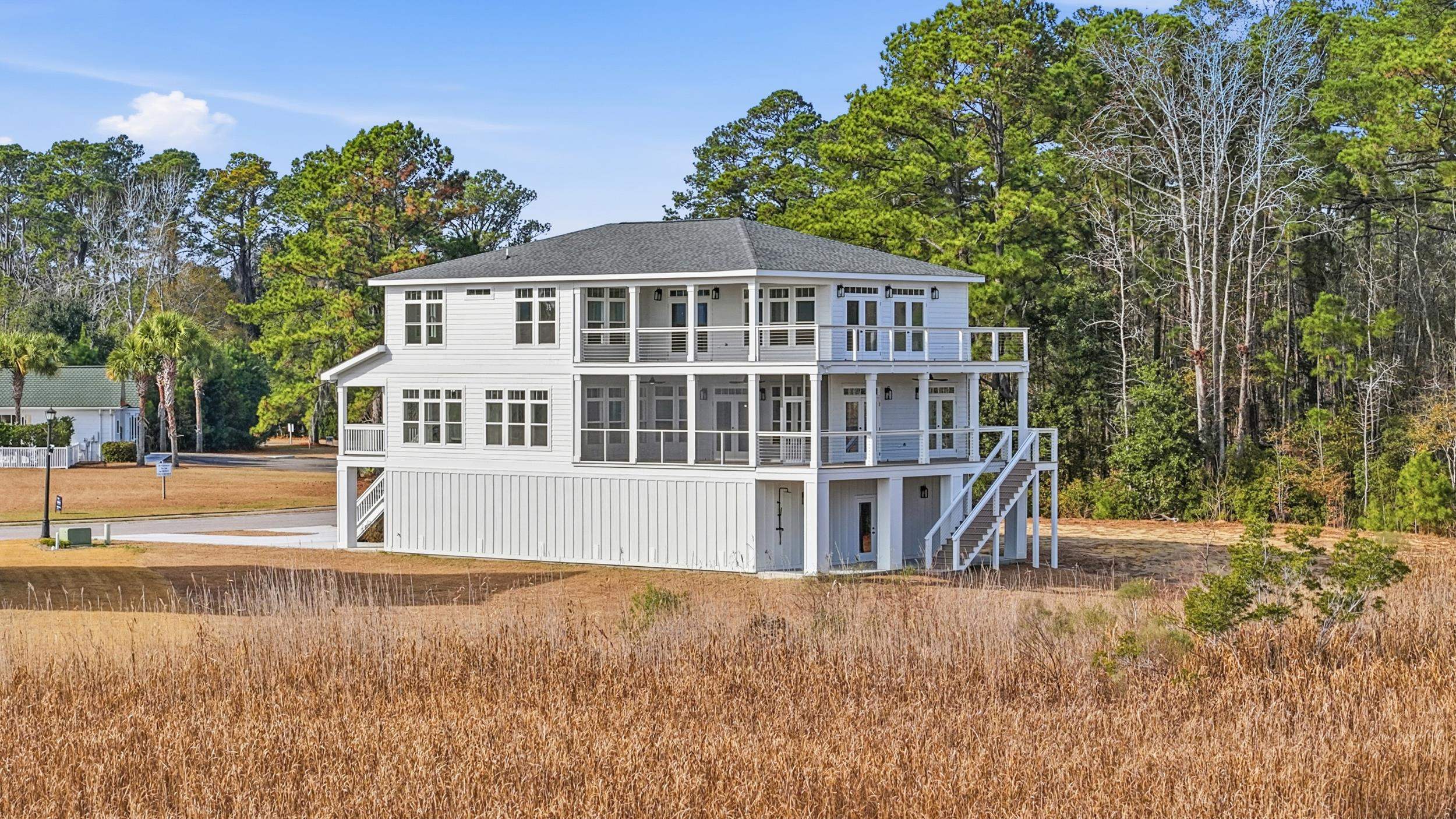 145 Oak Bay Drive Georgetown, SC 29440 - Photo 36 of 39 Back of house featuring stairway and a shingled roof