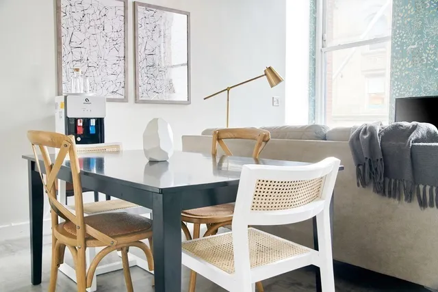 a view of a dining room with furniture and a window